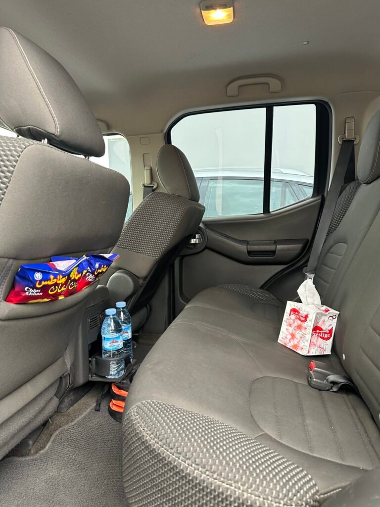 Water bottles and snacks provided for guests inside a tour vehicle.